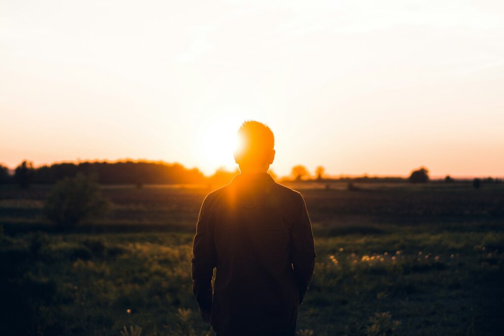 Photo by Warren silhouette of man facing sunset